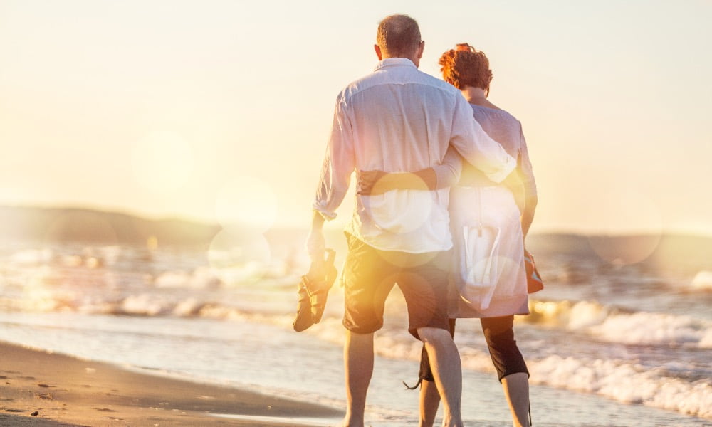 Close-up portrait of an elderly couple hugging on seacoast