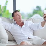 portrait of young man making self photo with his mobile phone
